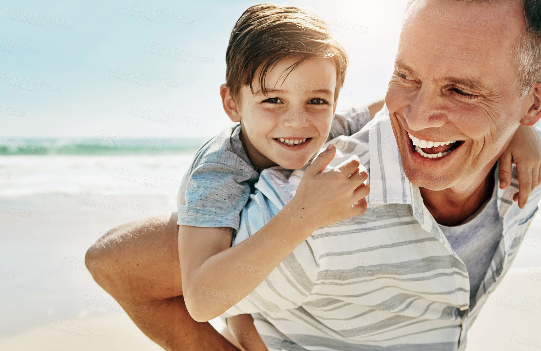 Buy stock photo Happy, piggyback and grandfather with child at beach for summer, fun and bonding on vacation in nature. Travel, freedom and mature man with kid at sea for holiday, playing and back ride games in Bali