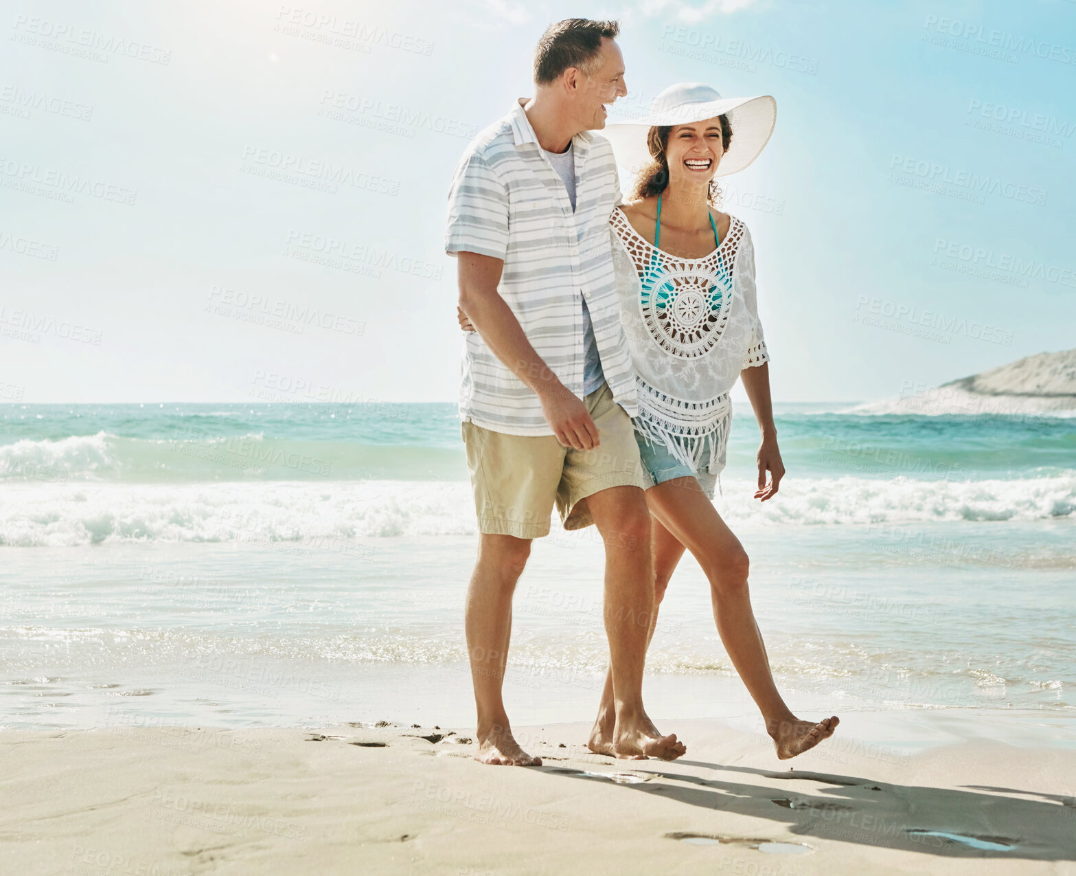 Buy stock photo Happy, couple and laughter at beach on romantic walk for bonding, love and time together in nature. Smile, man and woman with funny joke about marriage at seashore for commitment and relationship