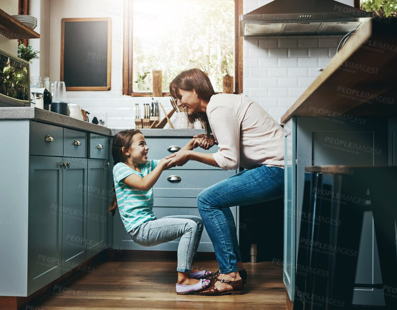 Buy stock photo Playful, girl and woman with fun in kitchen for weekend bonding, support and humor in childhood. Smile, happy and mom with little daughter at family home for love, funny joke and care in motherhood