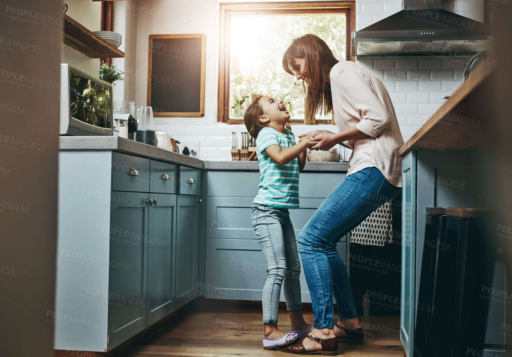 Buy stock photo Dancing, happy and mom with child in kitchen for bonding, fun and listening to music together. Smile, excited and mother teaching girl kid to groove to radio, playlist or song at home in Canada.