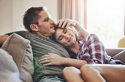 Buy stock photo Happy, couple and relax on sofa with hug at home for commitment, bonding and care on weekend. Calm, peace and man with affection to woman in living room for support, comfort and romance in marriage