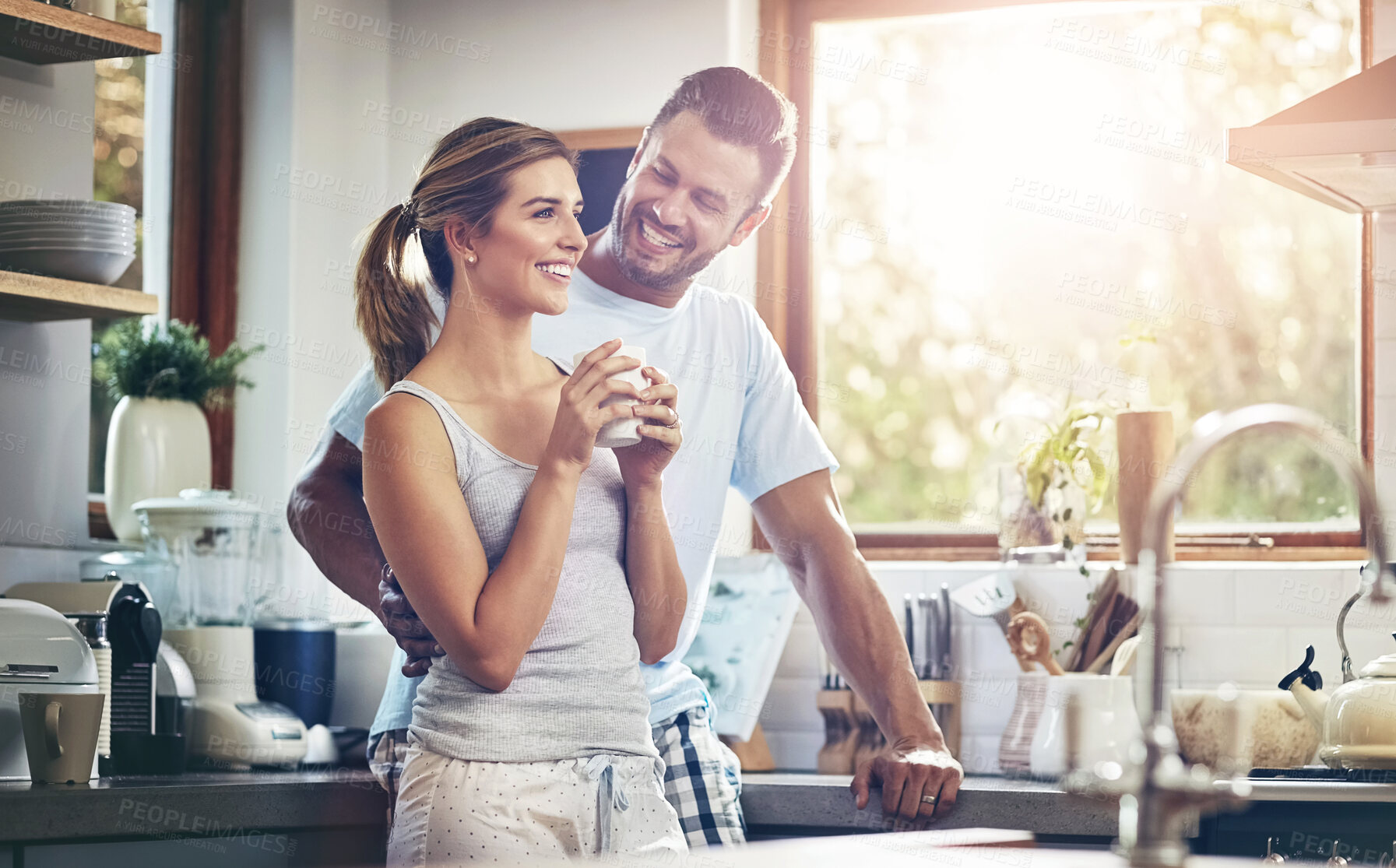 Buy stock photo Coffee, love and smile with couple in kitchen of home together for morning break or wellness. Cup, relax or romance with happy man and woman drinking fresh caffeine beverage in apartment for bonding