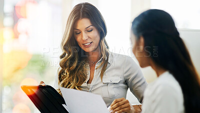 Buy stock photo Business women, tablet and meeting in office with discussion, planning and paperwork for feedback. Manager, employee and documents in workplace for review, conversation and strategy with report