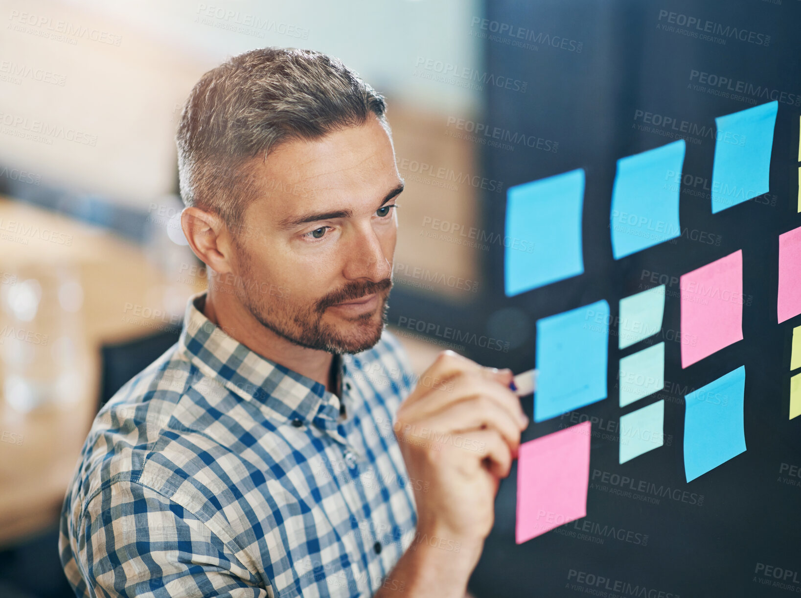 Buy stock photo Planning, man and sticky notes in office for writing, tasks and schedule glass board. Businessperson, strategy and idea on paper for calendar, brainstorming and agenda on window in workplace