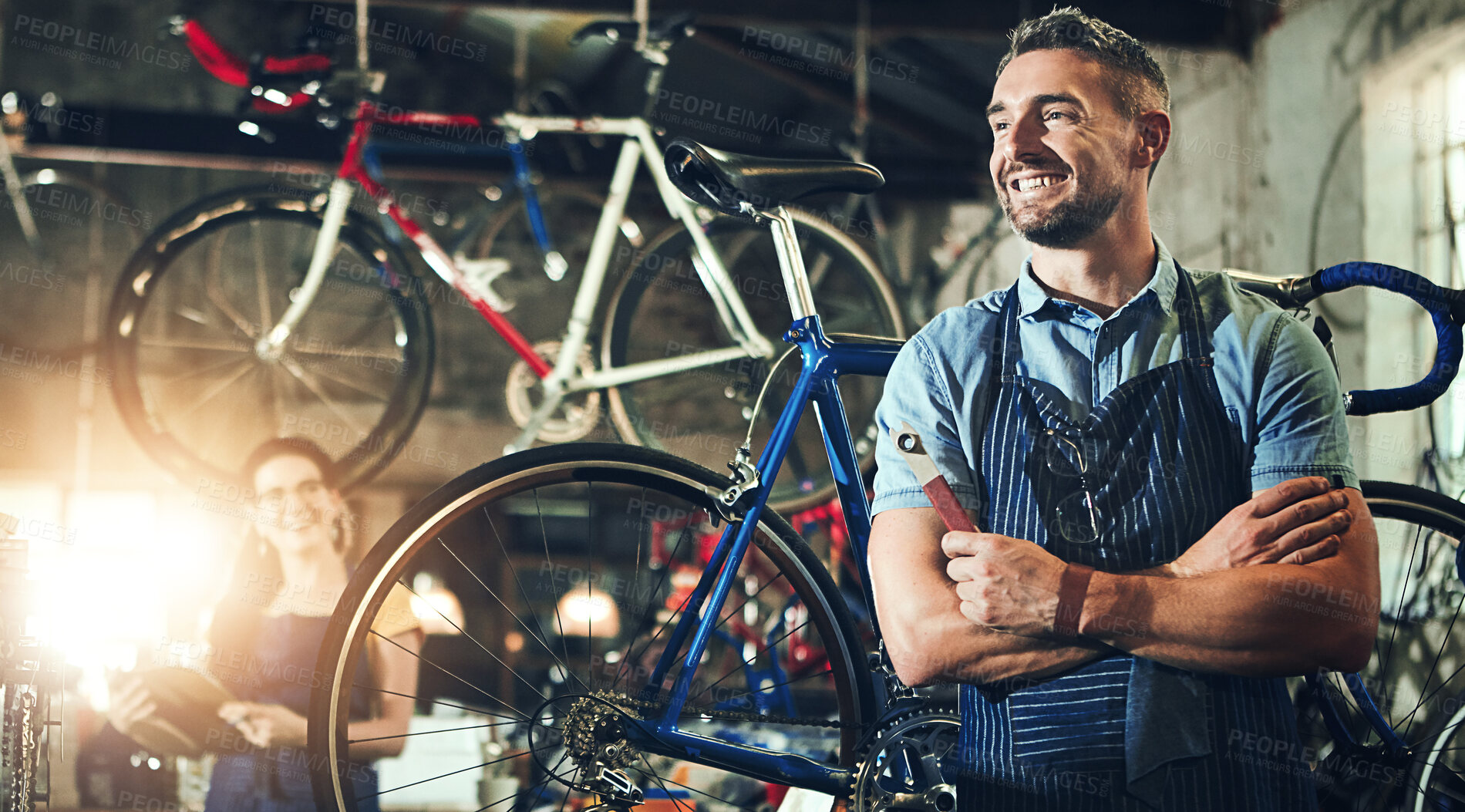 Buy stock photo Happy man, bicycle technician and professional with confidence in small business for fix, repair or maintenance. Confident male person, cycle engineer or bike mechanic with smile for job at workshop