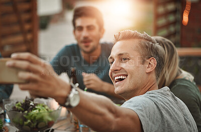 Buy stock photo Laughing, friends and selfie of man at dinner party for celebration at social gathering. Food, picture and group of people eating lunch together at event, reunion and excited for happy memory at home