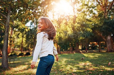 Buy stock photo Girl, child and playing in park with leaves for adventure, fun activity or spinning with enjoyment in summer. Kid, happy and excited with freedom, holiday or wellness on grass in nature with sunlight