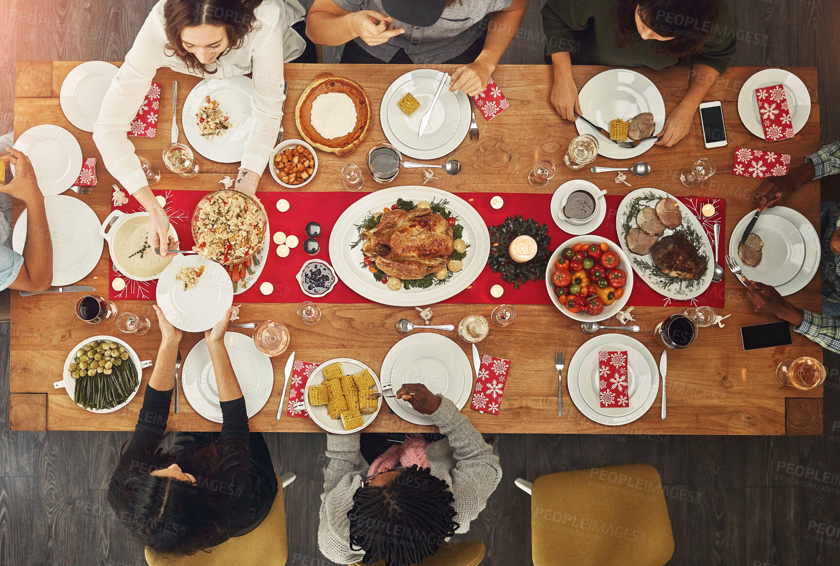 Buy stock photo Family, food and drink with people by table for eating, conversation and social event for celebration. Top view, tradition and lunch party with meal for nutrition, Christmas and festive at home