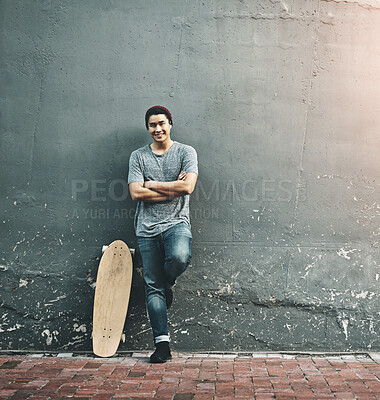 Buy stock photo Fashion, skateboard and portrait of man in city with trendy style, cool outfit and crossed arms outdoors. Happy, confidence and person on wall background for skateboarding, weekend fun and holiday