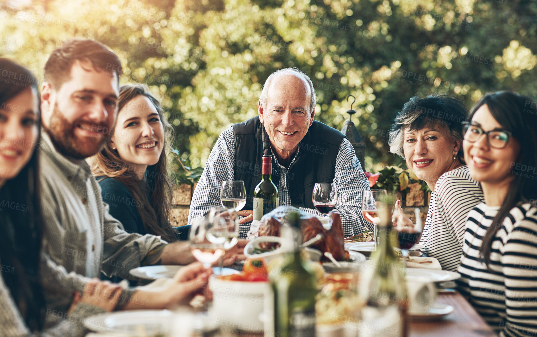 Buy stock photo Family, portrait and happy for thanksgiving, dinner and celebration outdoor with food, wine and love. Group of people, smile and together at table for holiday, event and turkey with drink or eating