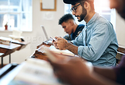 Buy stock photo Man, classroom and university with phone for research, reading message on mobile app at school. Male student, college or social media with education or learning, scroll for news story with internet