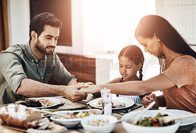 Buy stock photo Prayer, family and lunch at table for faith, gratitude and worship together at home. Holding hands, parents and child in dining room for food, support and healthy meal in afternoon for Christianity