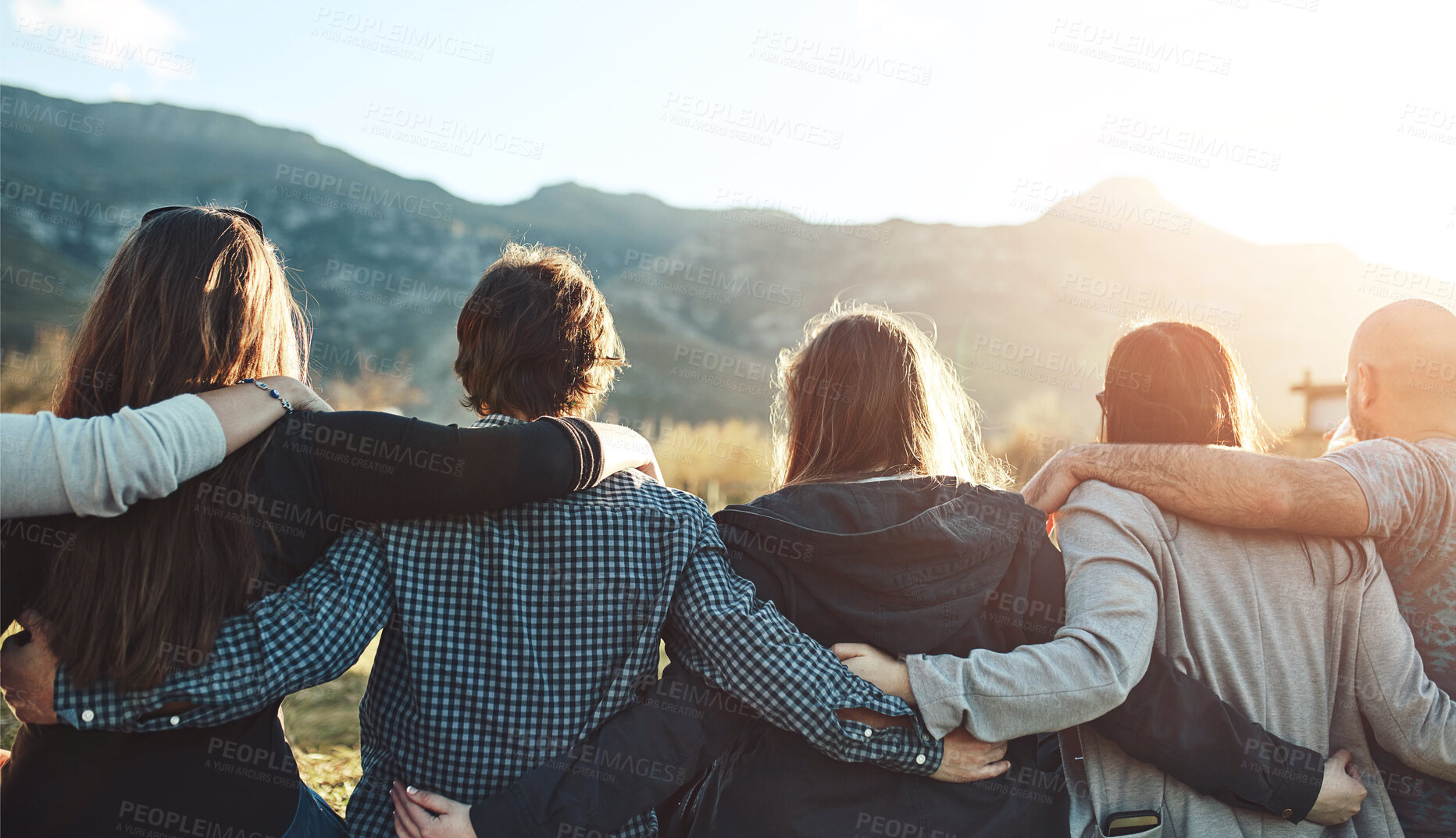 Buy stock photo Friends, sunset and group in nature with hug for adventure, travel or weekend trip in countryside. Back view, outdoor and people with embrace for vacation, support or bonding together in Australia