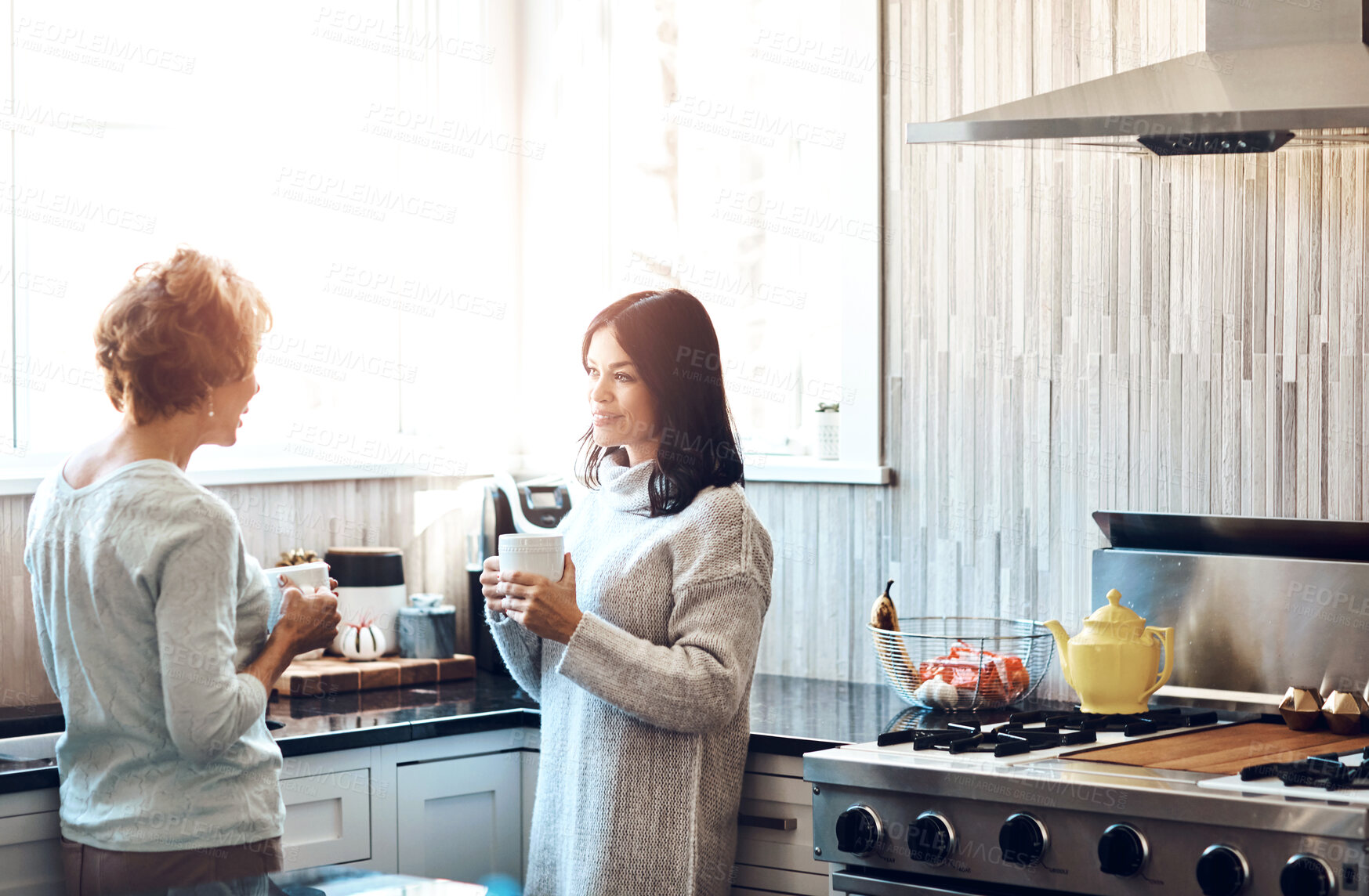 Buy stock photo Love, conversation and woman with senior mother in kitchen for coffee, bonding and support on weekend visit at home. Family, safety and daughter with elderly mom in house for chat, trust or advice