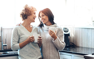 Buy stock photo Love, coffee and mother in conversation by daughter in kitchen, morning and support for parenting. Happy, smile and female person with mature mom, together and tea beverage or house relaxing