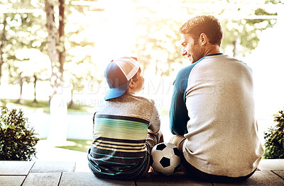 Buy stock photo Father, son and relax with soccer ball for sports, bonding or fun game together on porch at home. Back view of dad sitting with child, kid or little boy for football practice, holiday or weekend