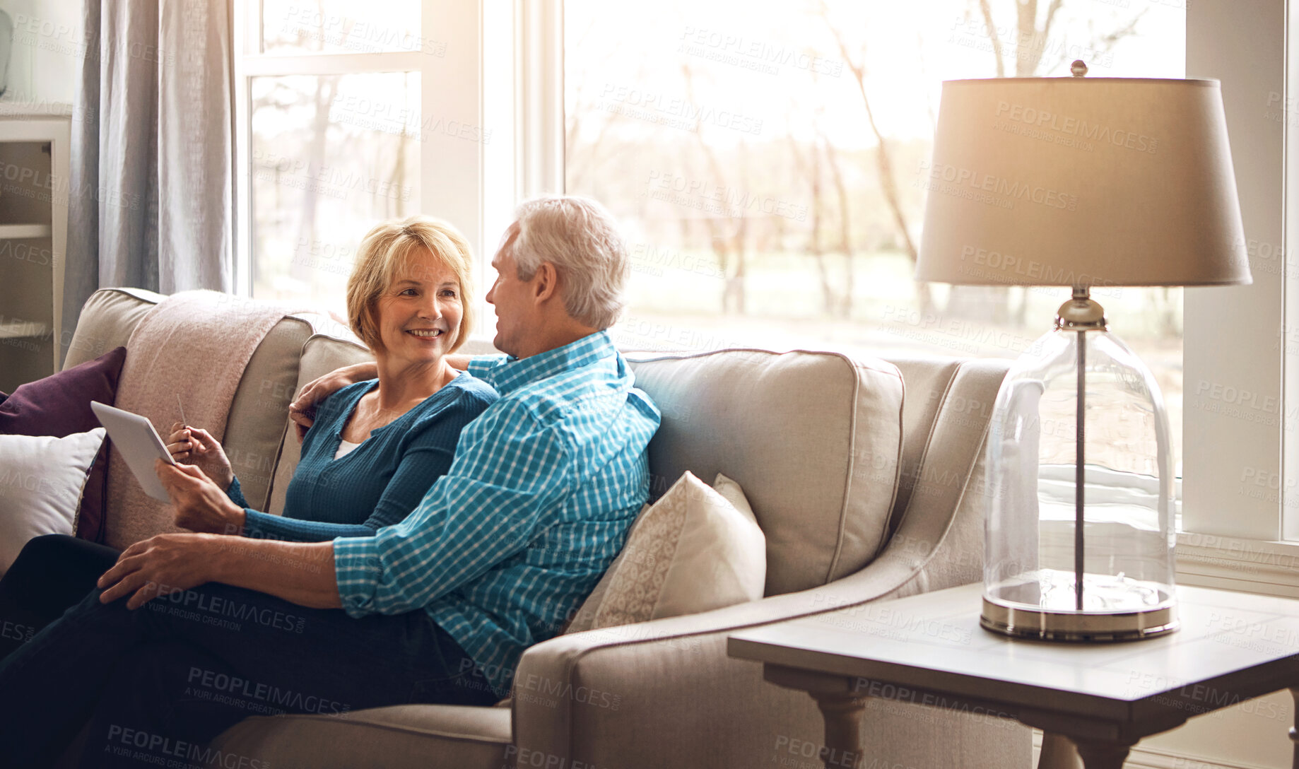 Buy stock photo Senior couple, tablet and happy on sofa in conversation, decision and search on web in home living room. Old man, elderly woman and smile for choice with video, streaming and movie on couch in house