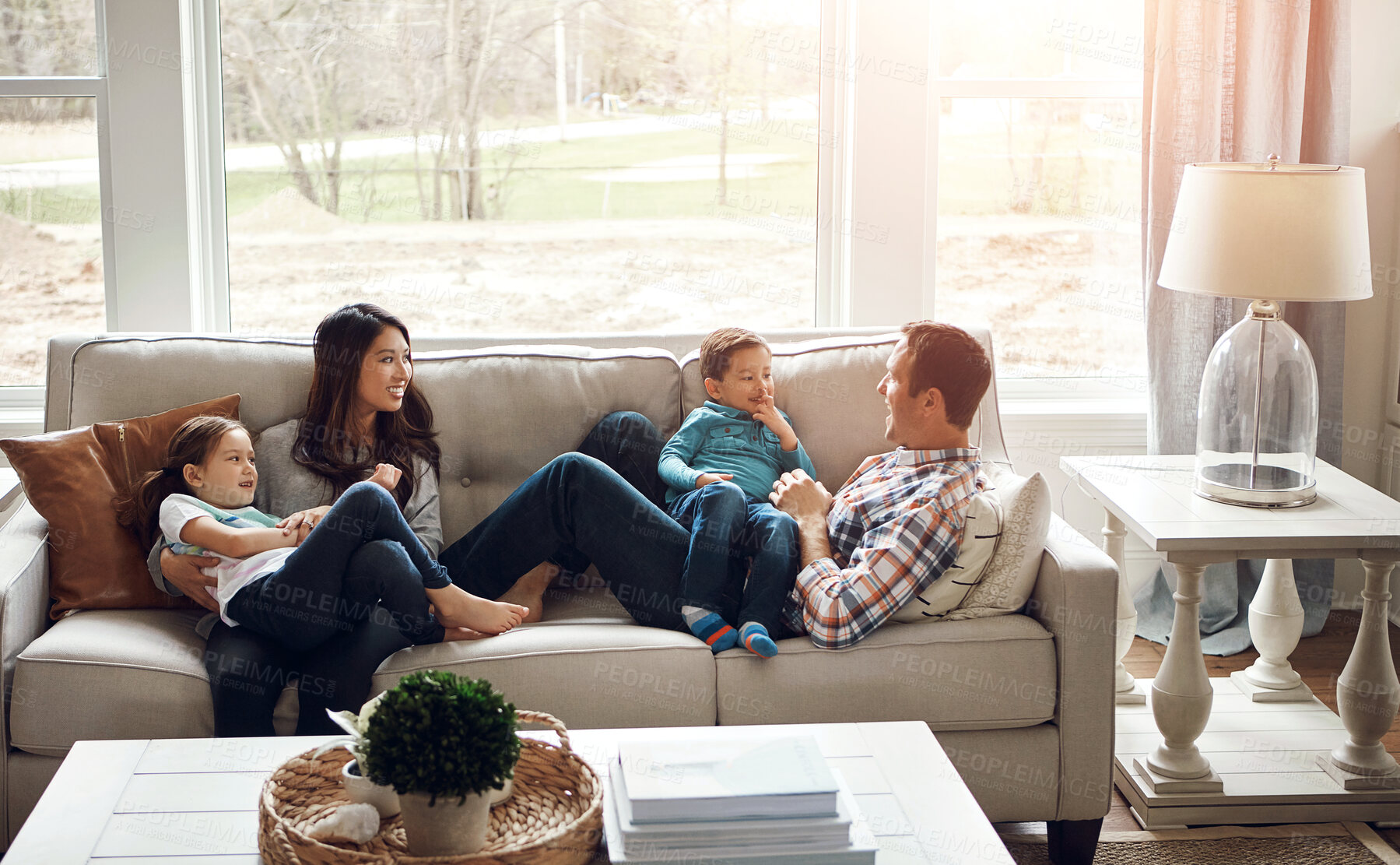 Buy stock photo Relax, children and happy family in home with parents together for care, love or bonding. Kids, mother and father on sofa for support, conversation or play with funny siblings laughing in living room