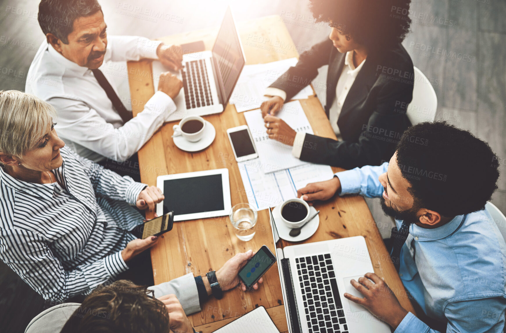 Buy stock photo Collaboration, meeting and technology with business people at table in boardroom of office from above. Corporate, planning or research with man and woman employee team in professional workplace