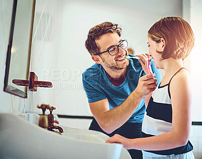 Buy stock photo Dental care, teaching and father brushing teeth with child for wellness, hygiene and morning routine. Bathroom, oral health and dad with girl kid for mouth cleaning treatment with toothbrush at home.