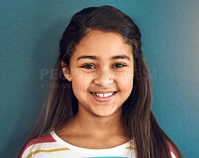 Buy stock photo Girl, child and portrait with smile in studio, happiness for education in New York City. Female student, elementary grade and cheerful for knowledge in classroom, back to school on blue background