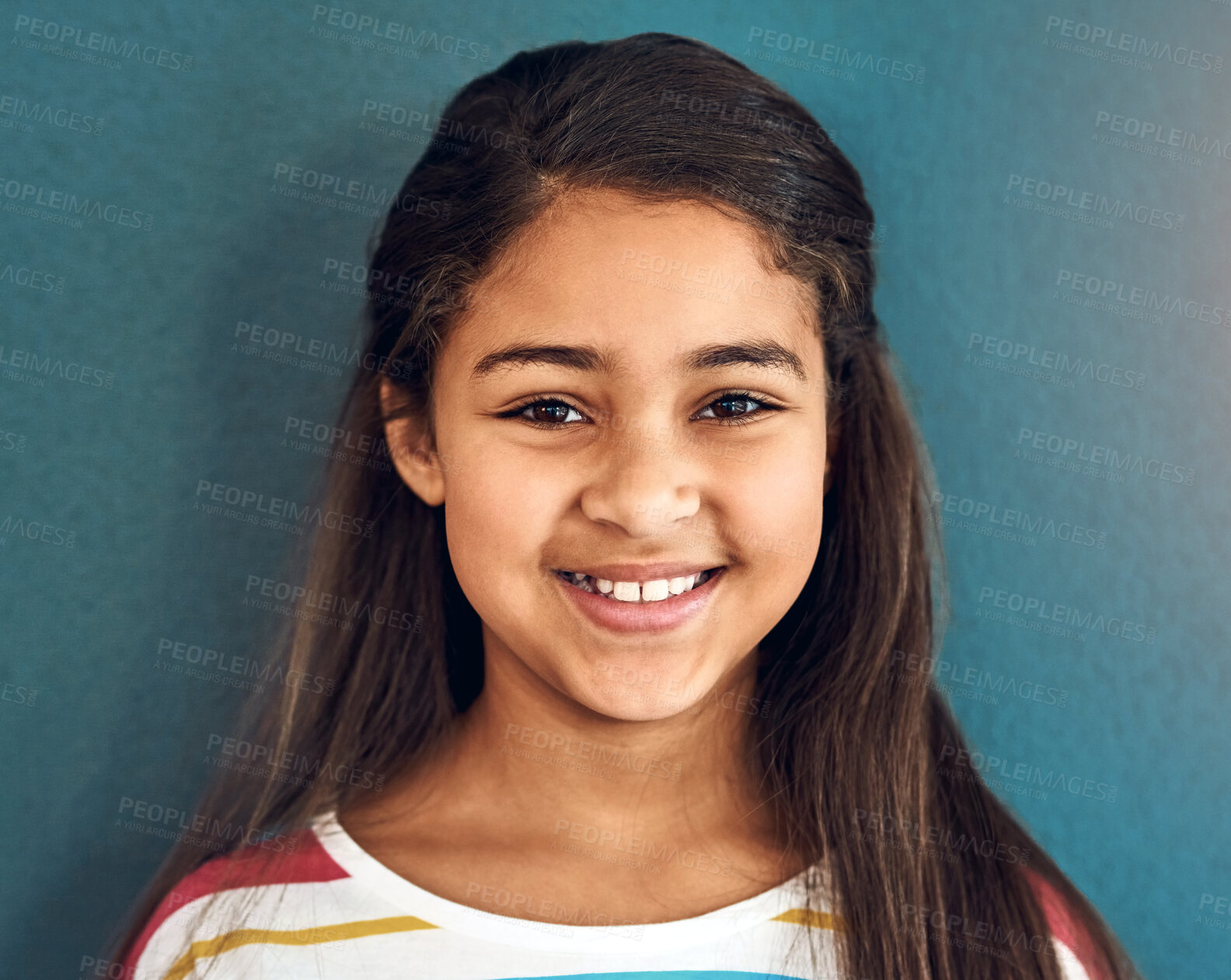 Buy stock photo Girl, child and portrait with smile in studio, happiness for education in New York City. Female student, elementary grade and cheerful for knowledge in classroom, back to school on blue background