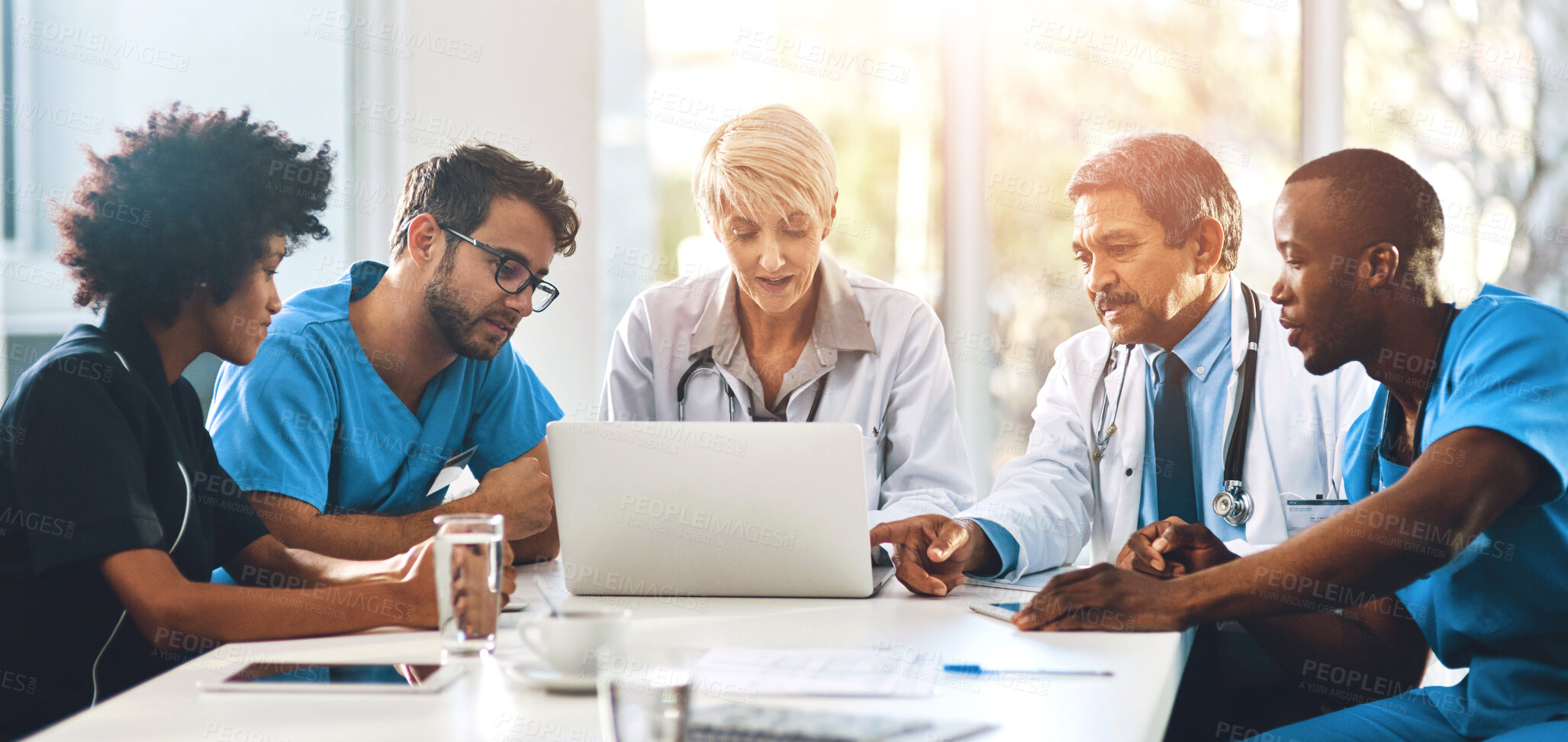 Buy stock photo Medical team, meeting and laptop in office for healthcare, discussion and expertise in hospital. Men, women and specialist at table for brainstorming, consulting and problem solving in boardroom