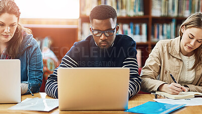 Buy stock photo Laptop, research and friends learning at library for education, knowledge or test preparation in college. University students, man and studying on computer for help, project notes and online report