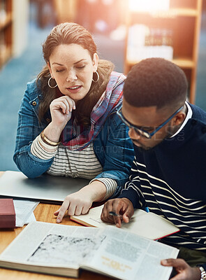 Buy stock photo Library, people and studying with book, desk and reading for exam, woman and man in campus of college. Students, friends and teamwork for test, information and table with research and together