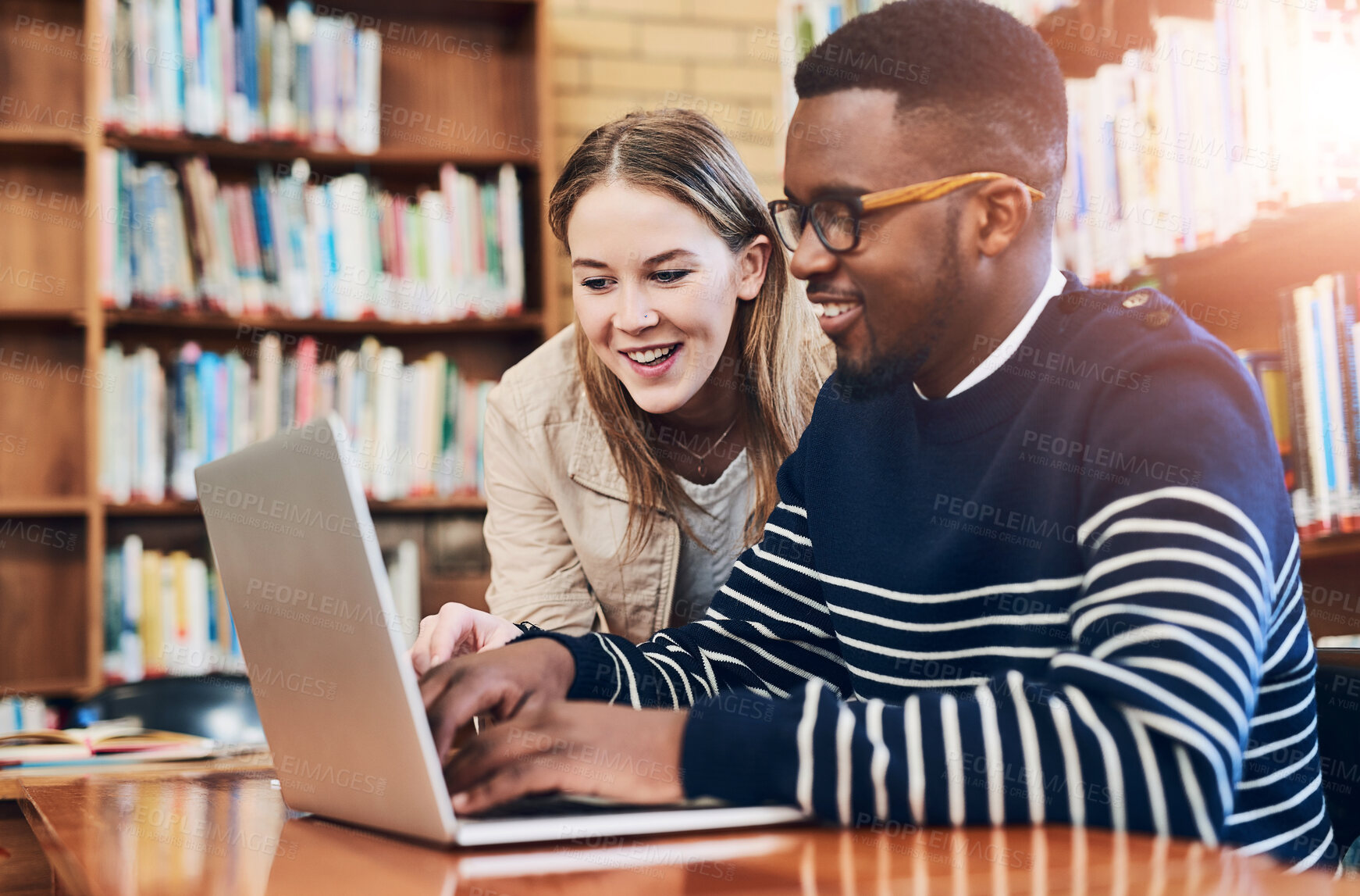 Buy stock photo People, students and laptop in library for research, education and exam preparation on campus. Man, woman and together with tech for studying, knowledge and learning on internet at university