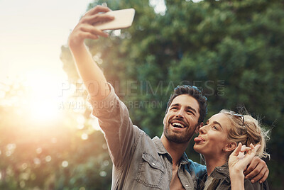 Buy stock photo Outdoor, couple and tongue out for selfie in vacation, adventure and bonding in California. People, man and woman with hug for photography, memories and profile picture for social media n nature