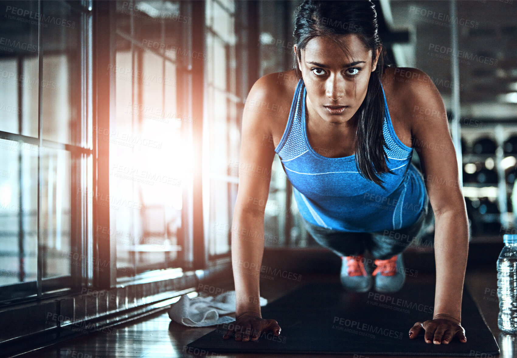 Buy stock photo Fitness, push up and woman in gym for workout with strength, wellness and arms training. Serious, health and female athlete with exercise for body goals for muscles and power in sports center.