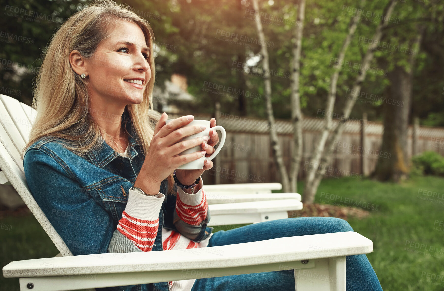 Buy stock photo Coffee, outdoor and woman relaxing in backyard for calm, peace and break on weekend at home. Smile, nature and mature female person on chair drinking cappuccino, latte or espresso in garden in Canada