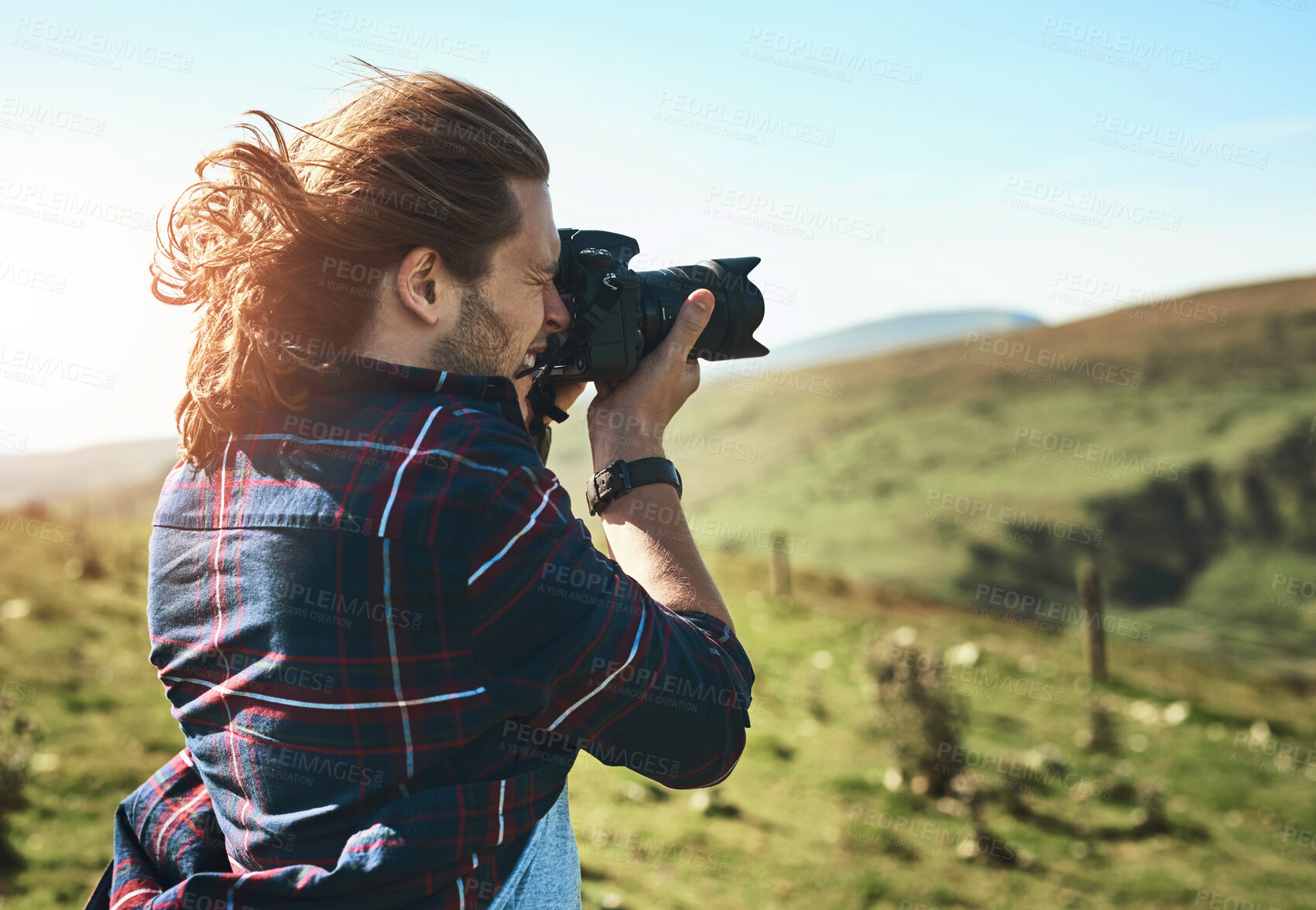 Buy stock photo Nature, photography and man in countryside with camera, memories and adventure in meadow. Professional photographer, outdoor and travel with tech for creativity, environment and field in Norway