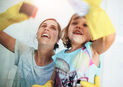 Buy stock photo Glass, spring cleaning or mother and daughter in house for learning, hygiene or responsibility in a bathroom. Happy family, love and mom with girl at home for shower screen, housekeeping or teaching