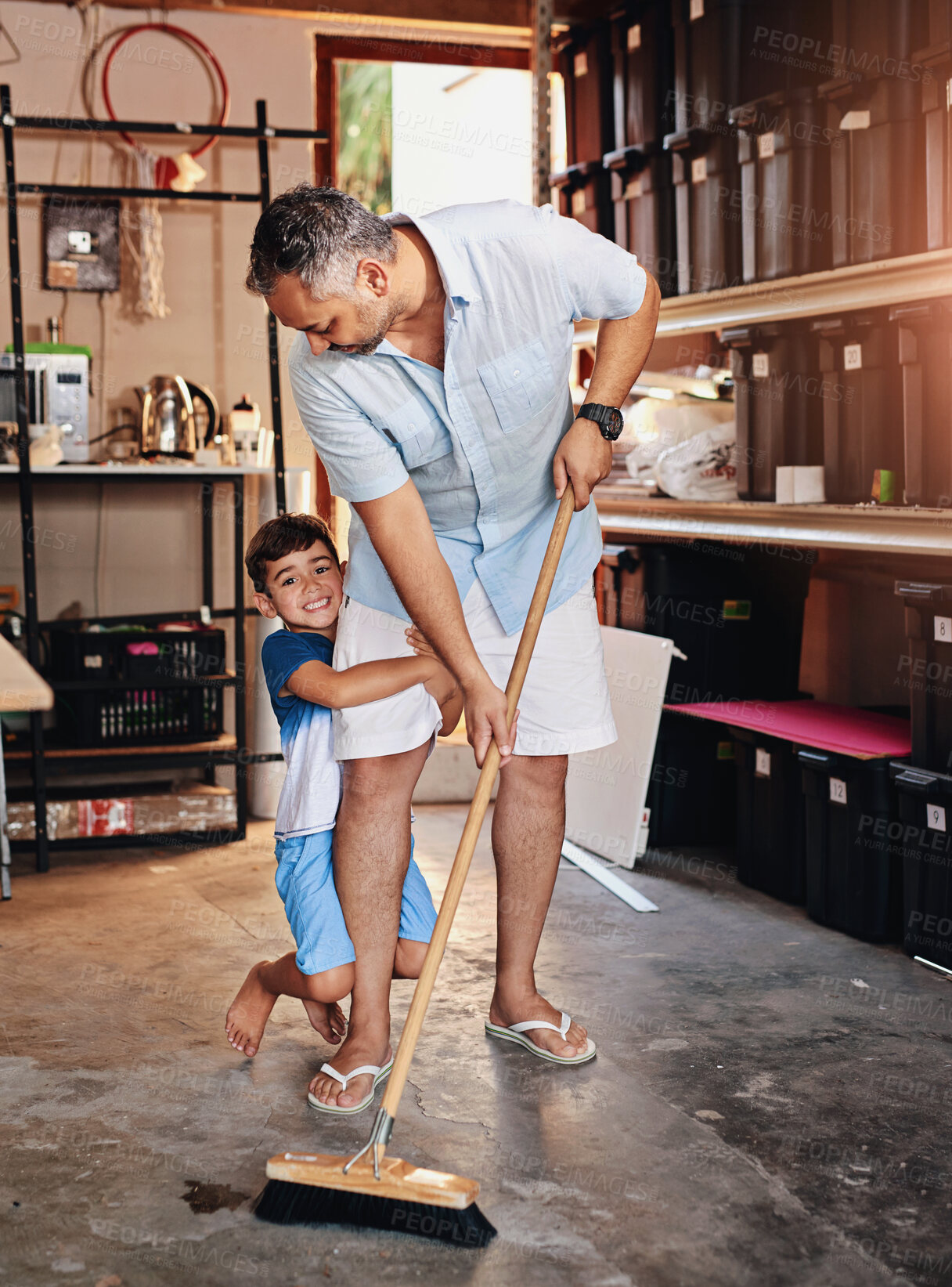 Buy stock photo Man, boy child and sweeping garage for bonding, broom for cleaning or dirt remove. Father, housework and happy son in home together for floor maintenance, weekend teamwork or family wellness