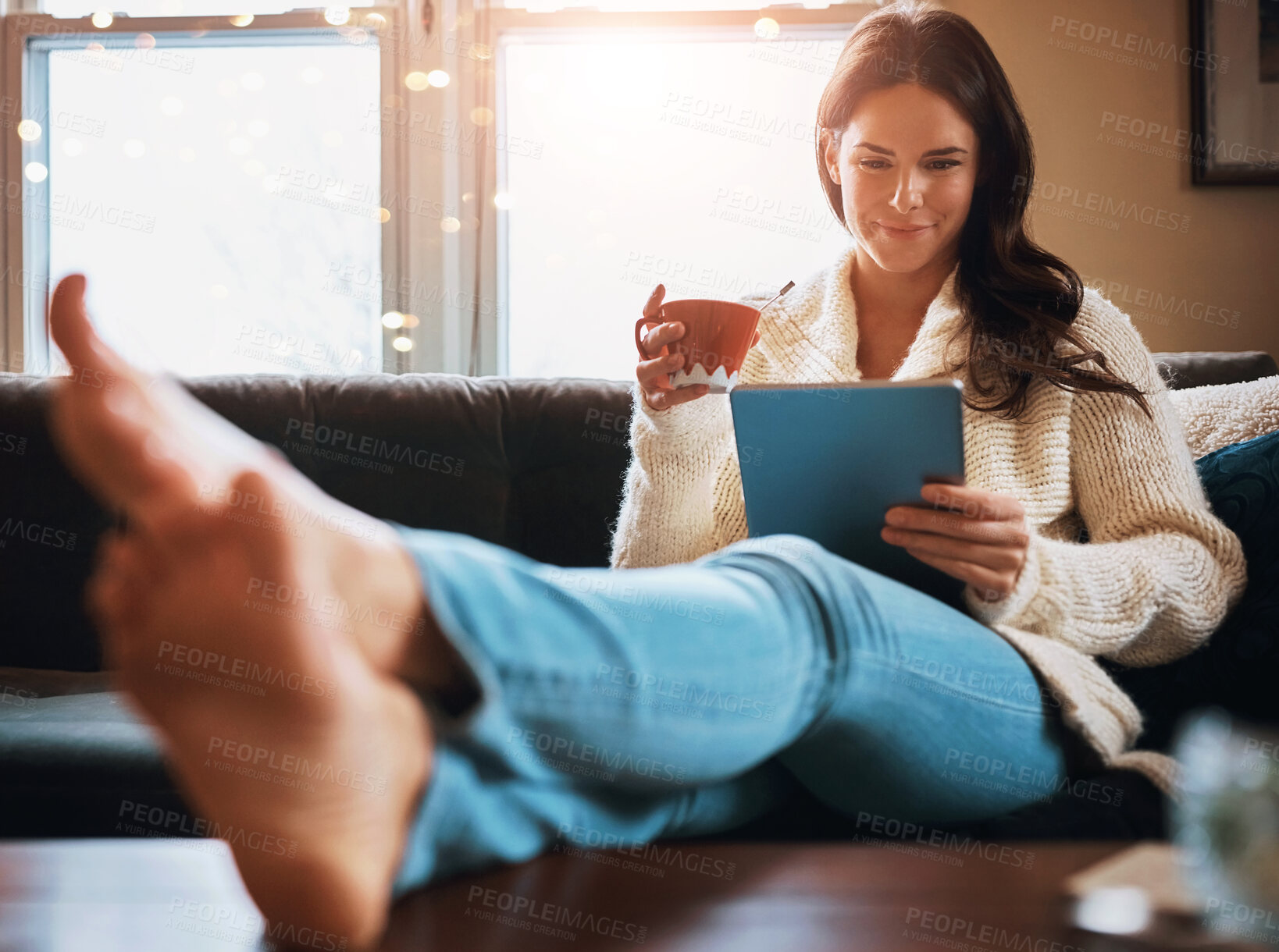 Buy stock photo Woman, happy and with coffee on tablet or sofa for social media, ebook and entertainment. Female person, home and living room on couch with smile for online or internet news and articles to relax