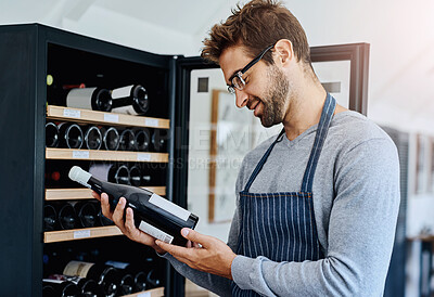 Buy stock photo Man, restaurant and waiter in wine cellar with smile for service, hospitality and professional. Employee, alcohol and happy or satisfied in winery with stock check for customer and luxury beverage