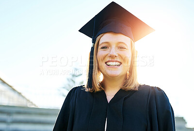 Buy stock photo Portrait, student and woman with smile, graduation and achievement with success, sunshine and cheerful. Face, person and girl in robe, outdoor and university with education, celebration and graduate