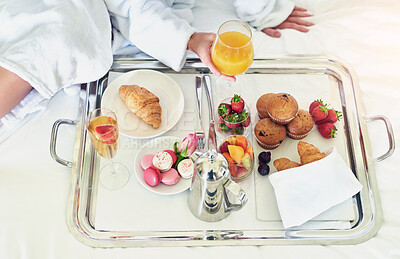 Buy stock photo Vacation, hands and food in bed for breakfast, hospitality and comfort in morning. Person, pastry and fruits with orange juice for meal, room service and hungry guest in bedroom of Spain hotel