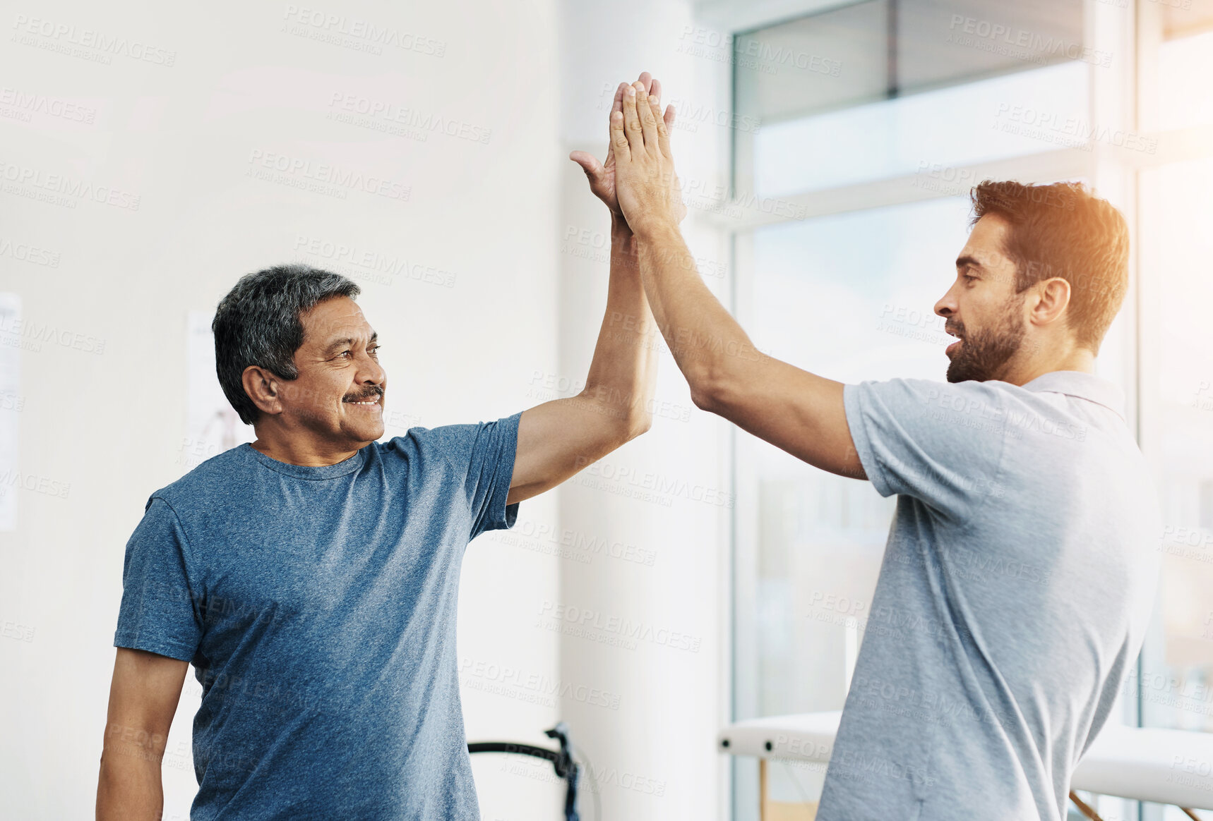 Buy stock photo Physiotherapy, smile and senior man with high five and healing with healthcare, wellness and celebration. Chiropractor, support and old person with a disability for rehabilitation and recovery