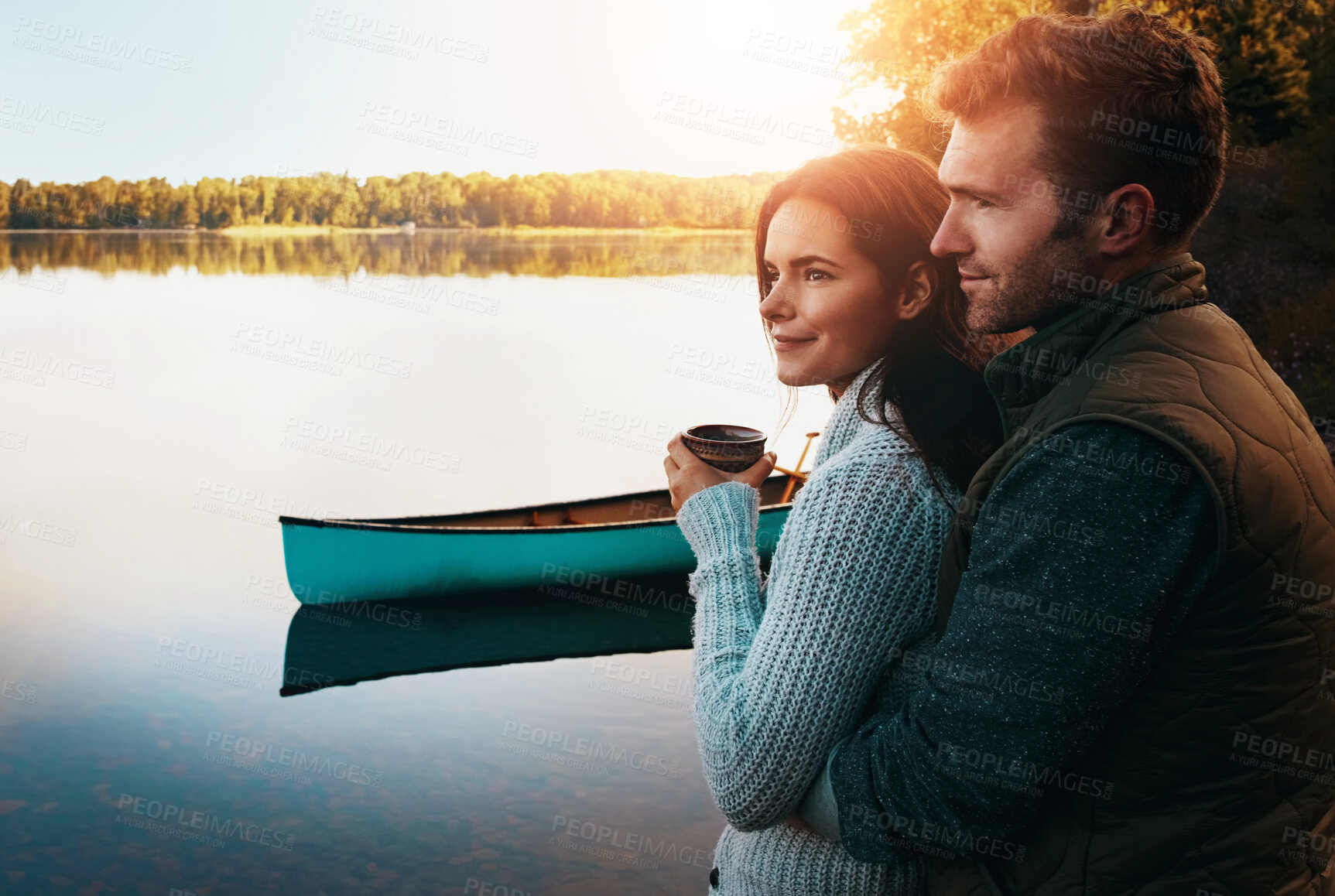 Buy stock photo Man, woman and relax together by lake for holiday, hug with morning coffee in winter. Happy couple, calm river and adventure travel in nature with kayak on water, vacation or journey with partner