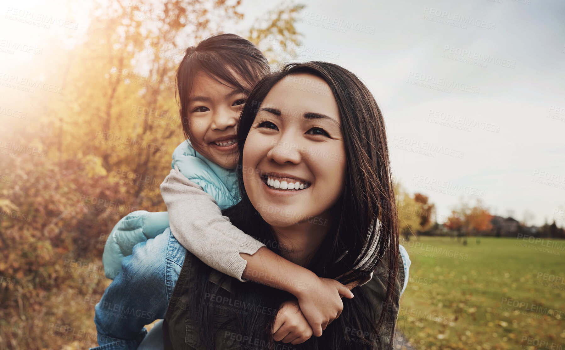 Buy stock photo Portrait, asian family and piggy back in park, bonding together and vacation in Japan. Face, parent and girl with smile, outdoor and mother carrying kid, nature and holiday with game for fun and joy