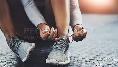 Buy stock photo Gym, hands and person tie shoes to start exercise, training or workout at health club closeup on floor. Legs, athlete and tying lace on sneakers to prepare or get ready for sport, fitness or wellness