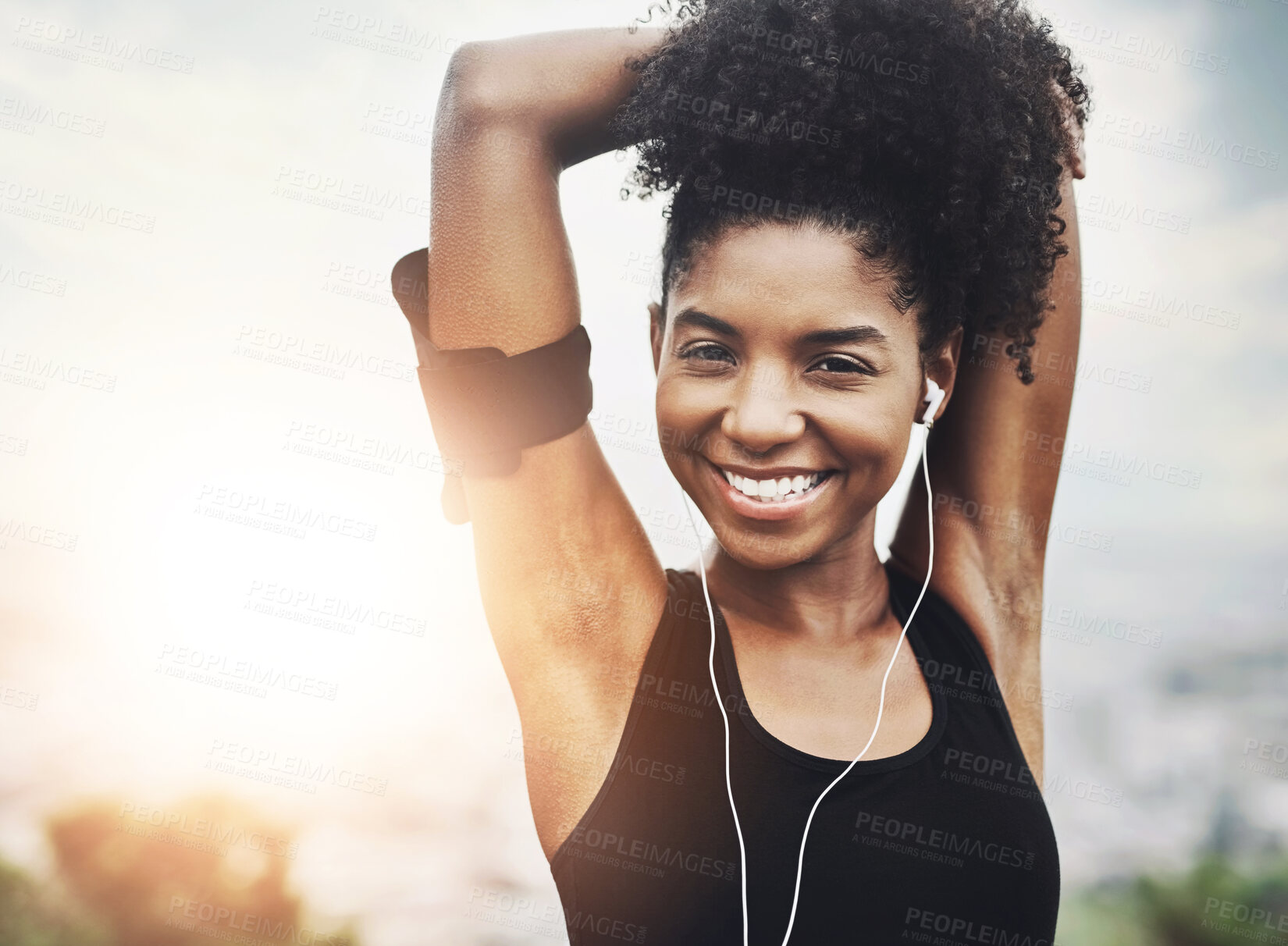 Buy stock photo Portrait, fitness and black woman stretching arms with smile, earphones and outdoor exercise in morning. Health, wellness and athlete girl at sunrise with warm up for muscle, workout and happy face