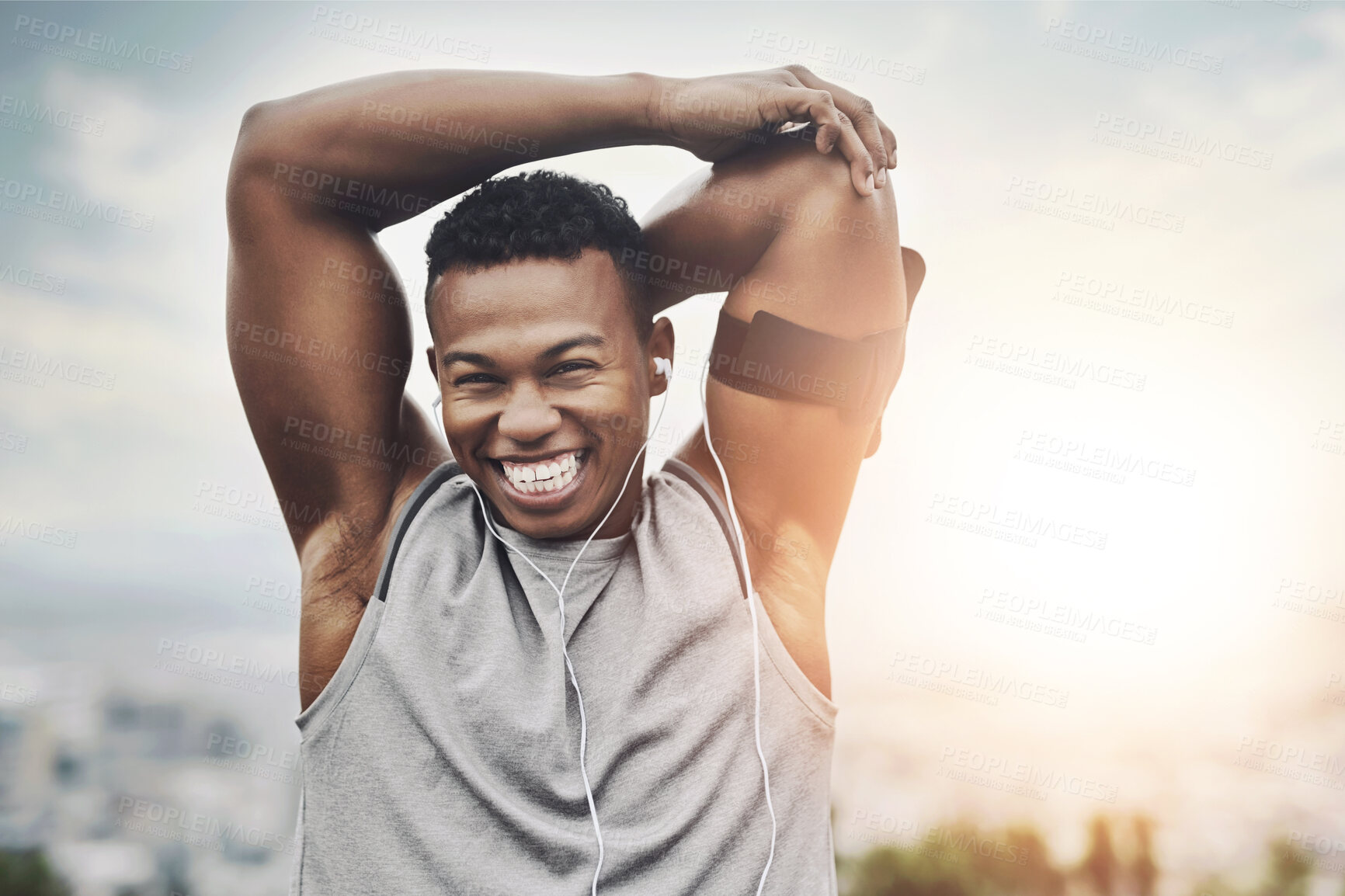 Buy stock photo Portrait, fitness and black man stretching arms with smile, earphones and outdoor exercise in morning. Health, wellness and athlete at sunrise with warm up for muscle, workout and happy face in city.