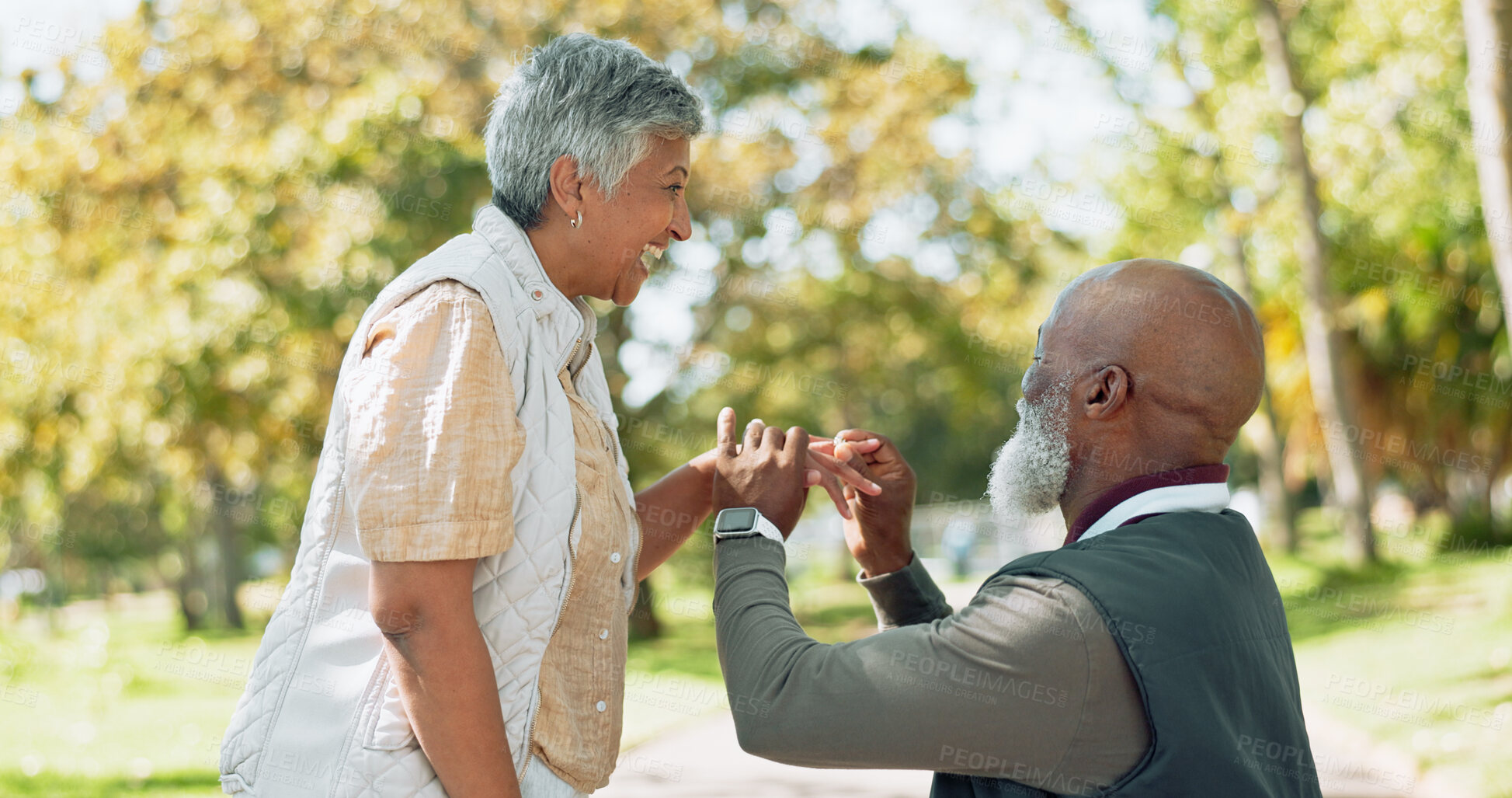 Buy stock photo Happy, mature couple and kneeling for engagement or surprise love gesture for commitment and dedication. Smile, senior people and outdoor proposal in nature for support and romance in retirement