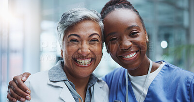 Buy stock photo Portrait, woman doctor and nurse hug in hospital with smile for healthcare, collaboration or support. Lens flare, medical team and professional health workers for happiness, teamwork or solidarity
