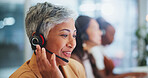 Mature woman, call centre and headset in office, telemarketing or customer service of client online sales support. Female agent, offer advice and talking, telecom or virtual guide for solution



