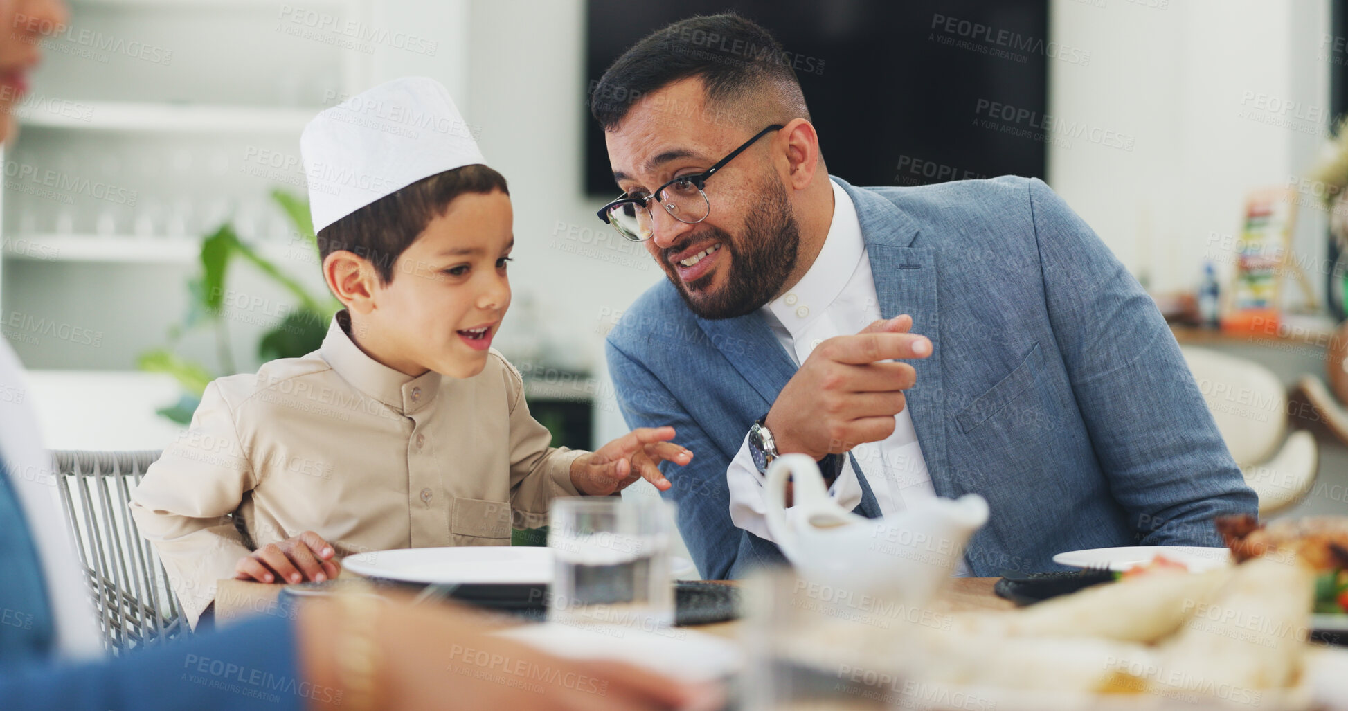 Buy stock photo Ramadan, talking and father with child at home for dinner, islamic celebration or waiting for food. Eid mubarak, culture or religious gathering with discussion, dad or son for bonding at dining table